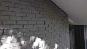 Exterior brick wall with cracks from foundation damage in Tyler TX