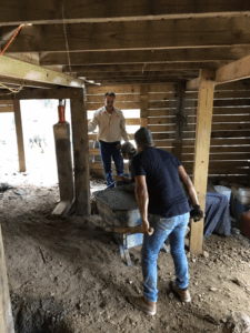 Pier post secured with concrete footing during pier and beam foundation repair in Tyler TX