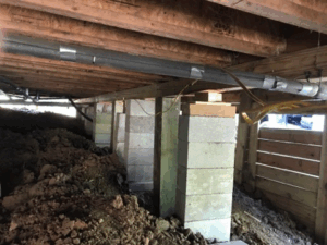 Crawl space pier and beam foundation repair with new concrete block supports in Tyler TX