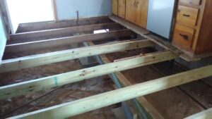 Open floor foundation repair with flooring removed inside Tyler TX home
